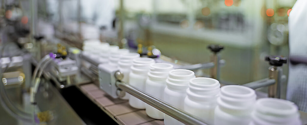 White bottles on a supplement assembly line