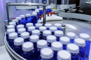 Blue bottles on a supplement manufacturing line