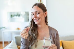 Woman taking women's health supplement for health benefits