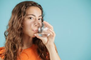 Young woman drink supplement for immune support in the winter