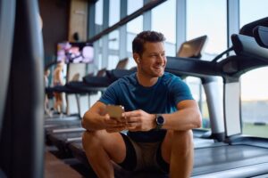 Man working out and watching supplement videos on YouTube