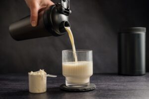 Protein and fiber supplement drink pouring into a cup.