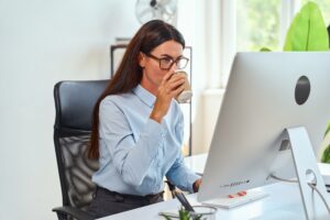 Woman at a desk experiencing calm, focused energy as part of her daily wellness routine