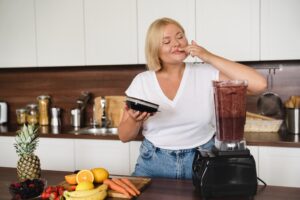 Woman smiling during her morning wellness routine supporting mood and metabolism
