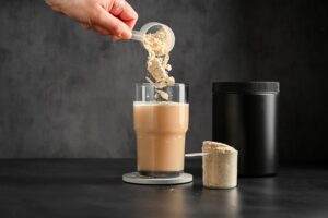 Woman tasting a flavored supplement powder drink as part of her daily wellness routine