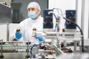 Supplement manufacturing production line representing the process of scaling a supplement brand to retail